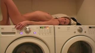 She lies on top of the washing machine